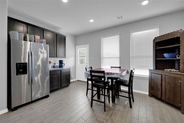 dining room featuring recessed lighting, baseboards, visible vents, and light wood finished floors