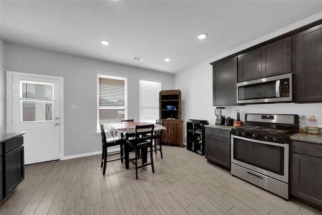 kitchen with stainless steel appliances, recessed lighting, visible vents, and light wood-style flooring