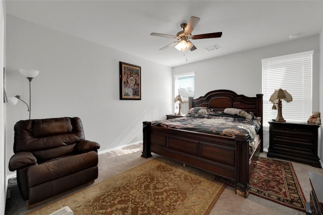 bedroom featuring ceiling fan, carpet floors, visible vents, and baseboards