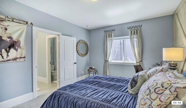 carpeted bedroom with baseboards and ensuite bathroom