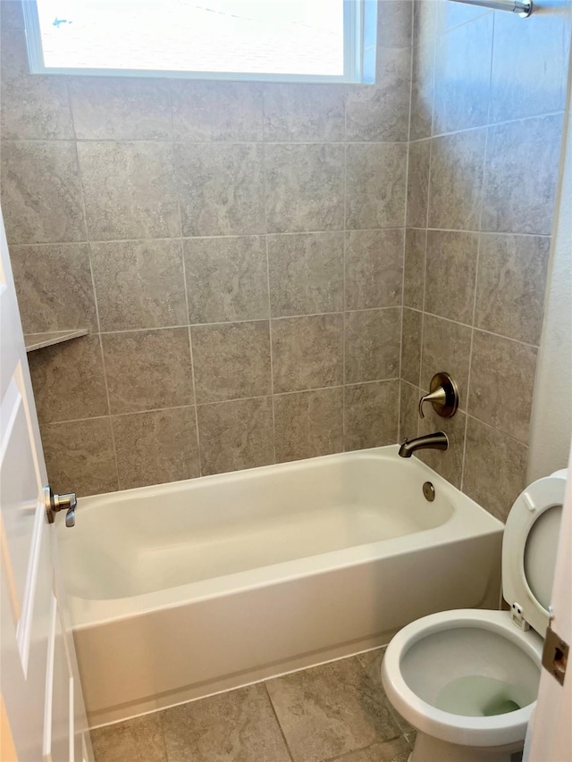 full bath featuring tile patterned floors, toilet, and shower / tub combination