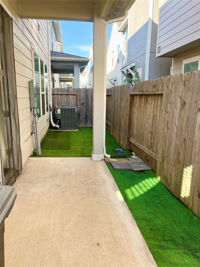 view of yard with cooling unit, a patio, and fence