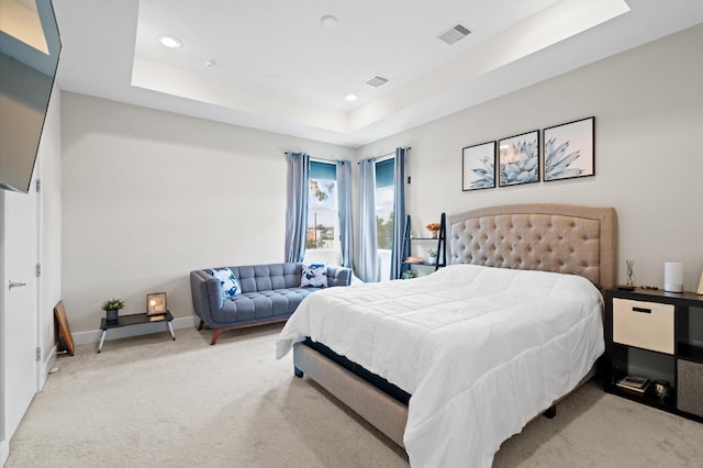 bedroom featuring a raised ceiling, carpet flooring, baseboards, and visible vents