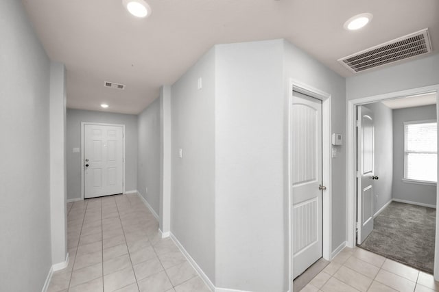 hall with baseboards, light tile patterned flooring, visible vents, and recessed lighting