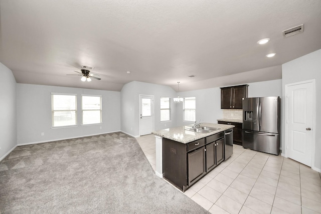 kitchen with light tile patterned floors, tasteful backsplash, visible vents, appliances with stainless steel finishes, and a sink