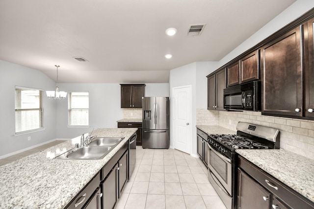 kitchen with dark brown cabinets, appliances with stainless steel finishes, a sink, and visible vents