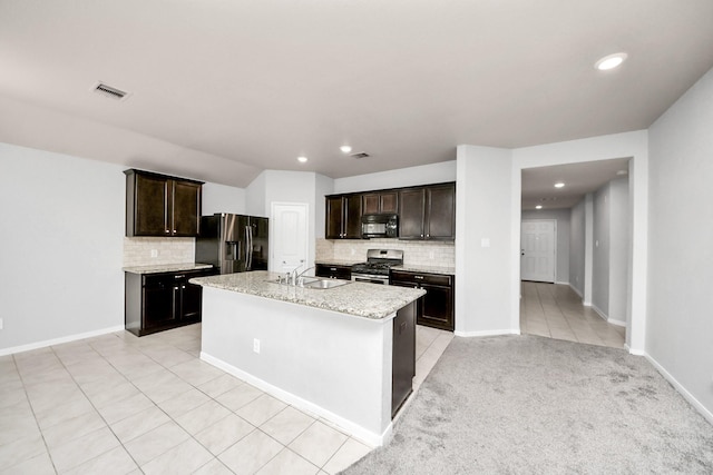 kitchen with black microwave, light tile patterned floors, visible vents, refrigerator with ice dispenser, and stainless steel range with gas cooktop