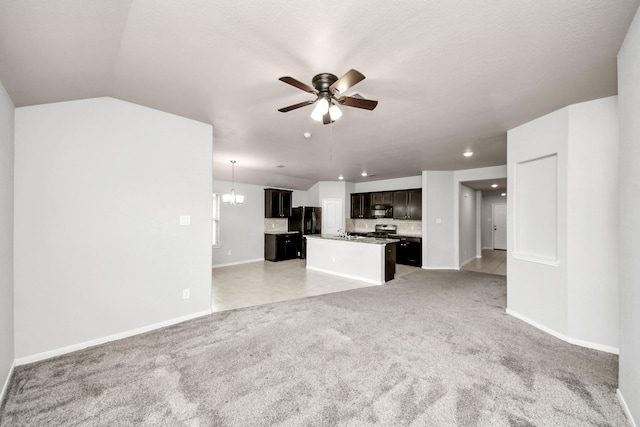 unfurnished living room with light carpet, recessed lighting, baseboards, and ceiling fan with notable chandelier