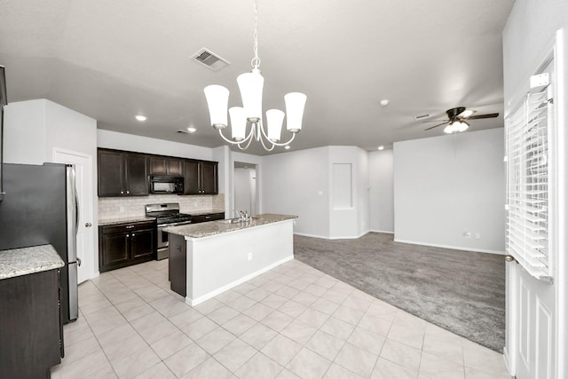 kitchen with light colored carpet, appliances with stainless steel finishes, pendant lighting, backsplash, and ceiling fan with notable chandelier