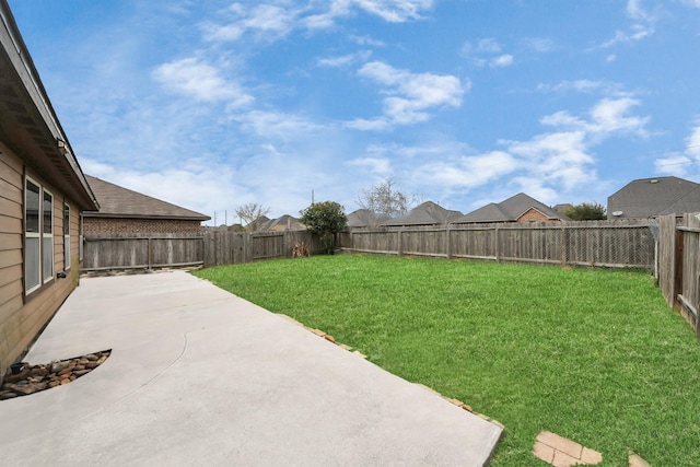 view of yard featuring a patio area and a fenced backyard