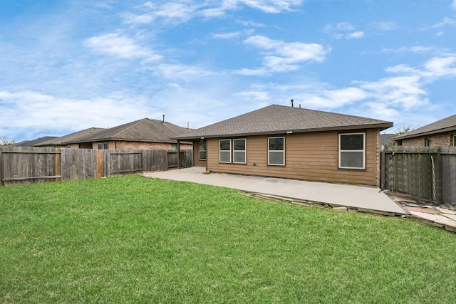 back of house with a yard, a fenced backyard, a patio, and roof with shingles