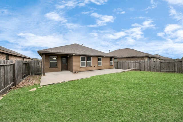 rear view of house featuring a yard, a fenced backyard, and a patio