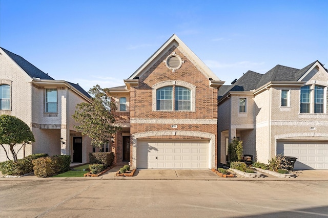 traditional-style house with brick siding, driveway, and an attached garage