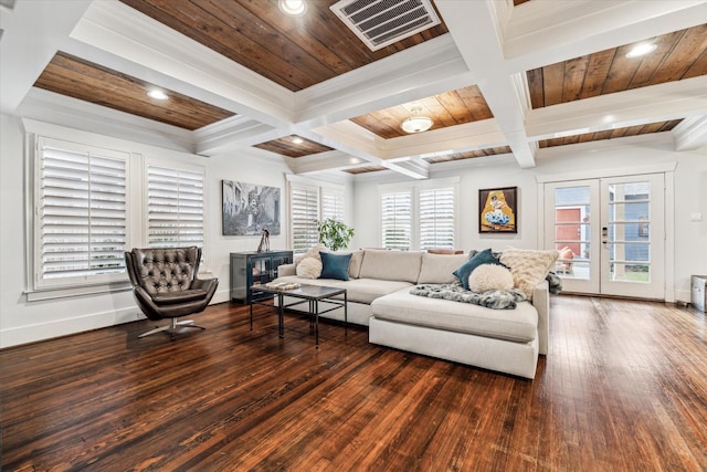 living room featuring french doors, visible vents, wood ceiling, a wood stove, and baseboards