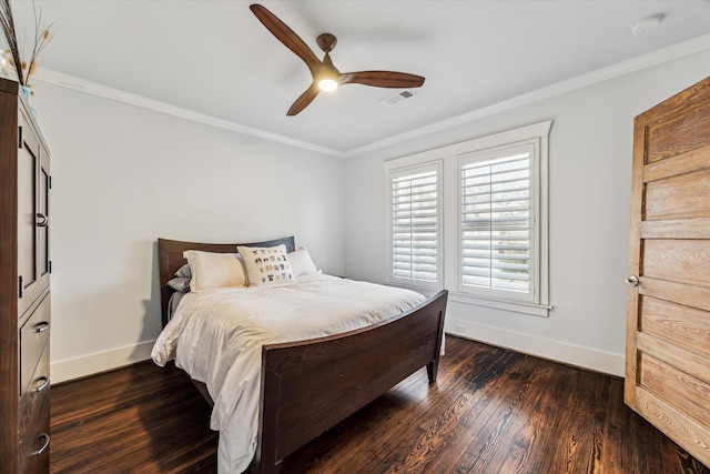 bedroom with ornamental molding, visible vents, dark wood finished floors, and baseboards