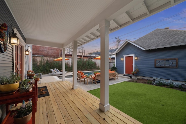 wooden deck featuring fence, outdoor lounge area, and a yard