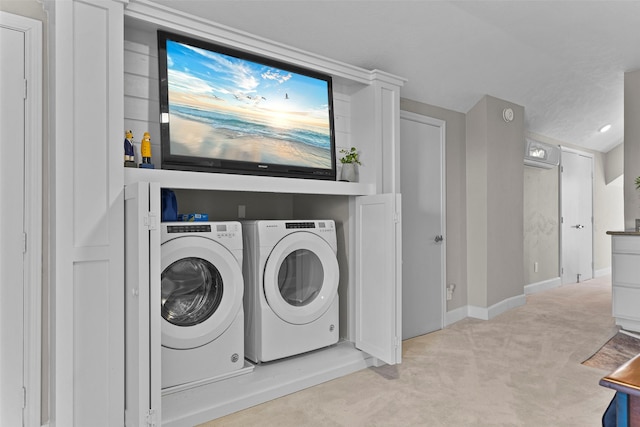 laundry room with laundry area, separate washer and dryer, carpet, and baseboards