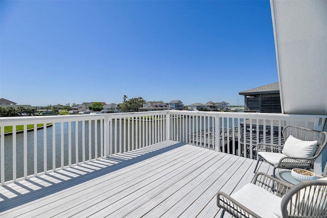 deck featuring a residential view and a water view