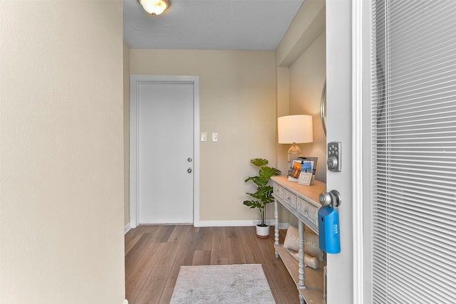 entrance foyer with wood finished floors and baseboards