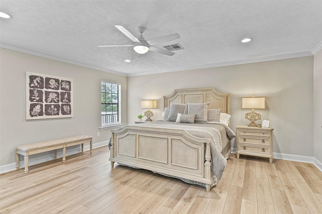 bedroom with ornamental molding, light wood-type flooring, visible vents, and baseboards