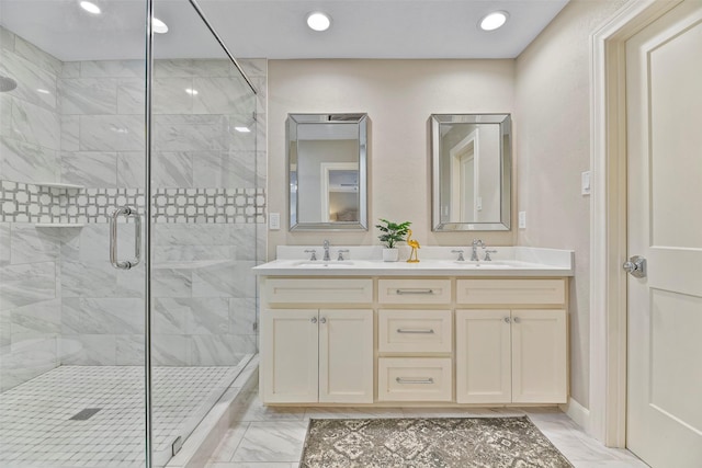 bathroom with a stall shower, marble finish floor, and a sink