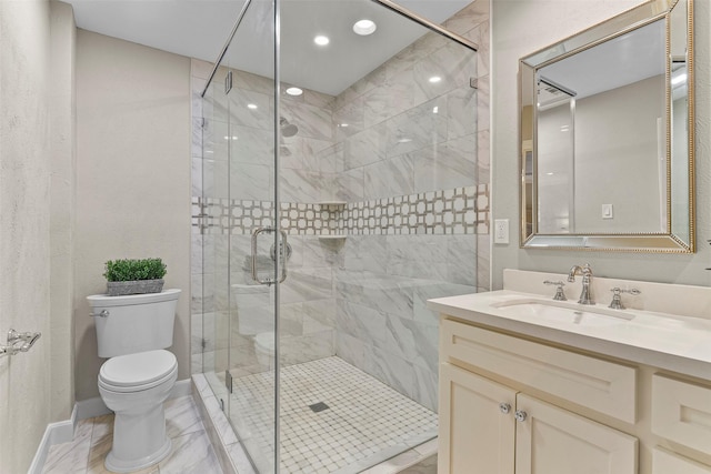 bathroom featuring marble finish floor, toilet, a stall shower, vanity, and baseboards