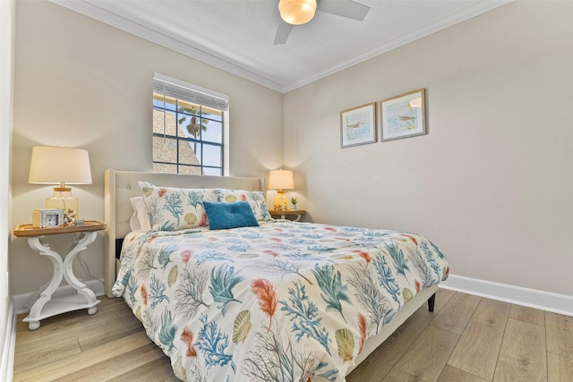 bedroom with ceiling fan, crown molding, baseboards, and wood finished floors