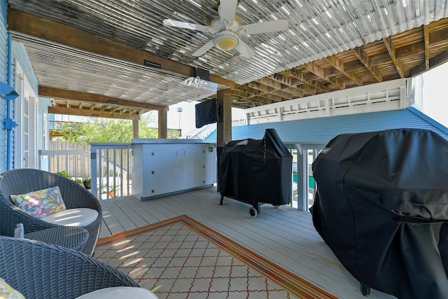 wooden terrace featuring a ceiling fan and area for grilling