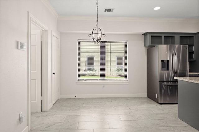 unfurnished dining area with crown molding, baseboards, visible vents, and a chandelier