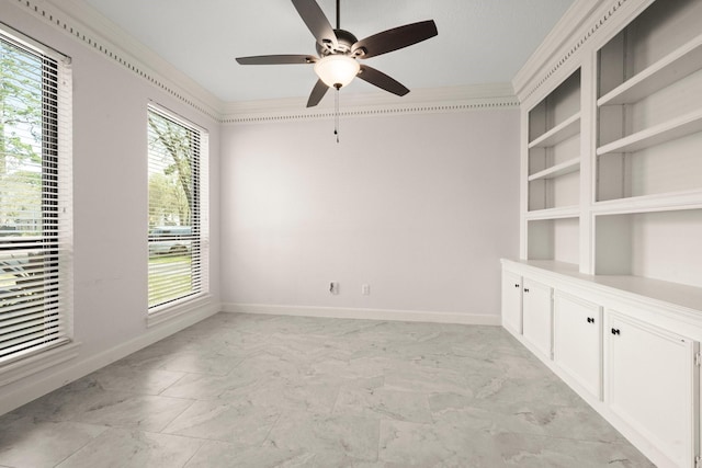 spare room with ceiling fan, baseboards, marble finish floor, and ornamental molding