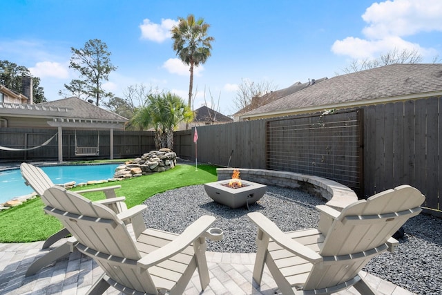 view of patio with a fenced in pool, an outdoor fire pit, and a fenced backyard