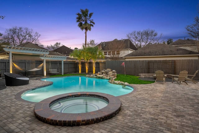 pool at dusk with a patio area, a fenced in pool, an in ground hot tub, and a fenced backyard