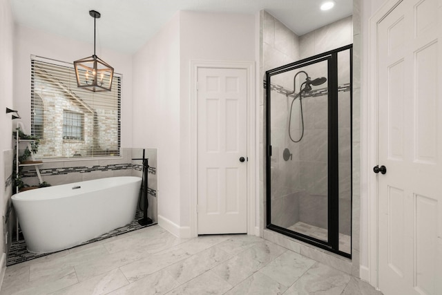 full bathroom with a soaking tub, marble finish floor, and a stall shower