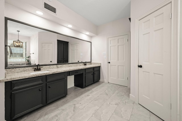 bathroom featuring visible vents, double vanity, a notable chandelier, marble finish floor, and a sink