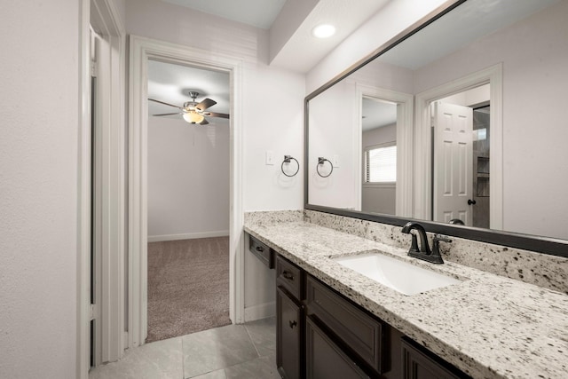 bathroom featuring baseboards, ceiling fan, vanity, and tile patterned flooring