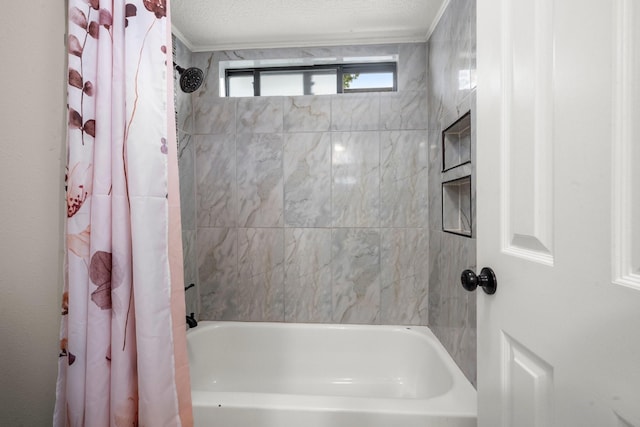 bathroom featuring a textured ceiling, shower / bath combo with shower curtain, and crown molding