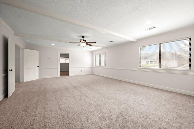 empty room with visible vents, a textured ceiling, baseboards, and carpet floors