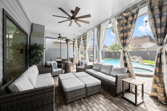 sunroom / solarium with a ceiling fan