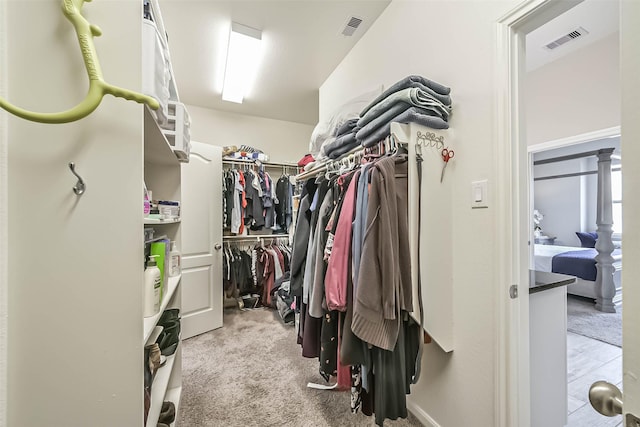 walk in closet with carpet floors and visible vents