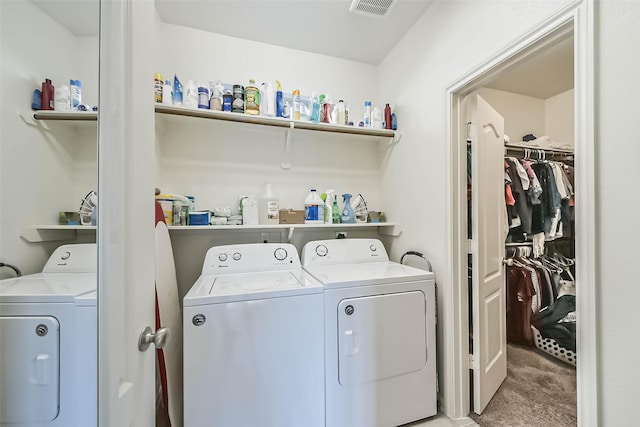 laundry area with laundry area, visible vents, washer and clothes dryer, and light colored carpet