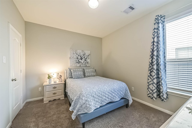 bedroom featuring carpet flooring, visible vents, and baseboards