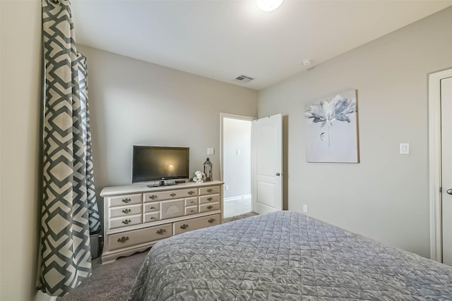 bedroom with visible vents and carpet flooring