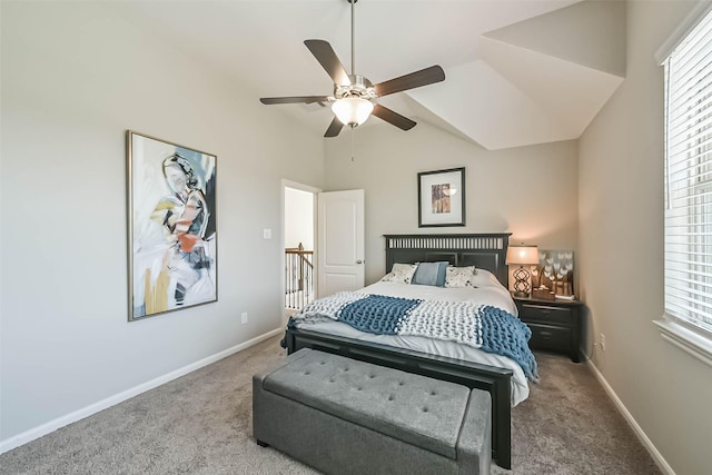 carpeted bedroom featuring vaulted ceiling, ceiling fan, multiple windows, and baseboards