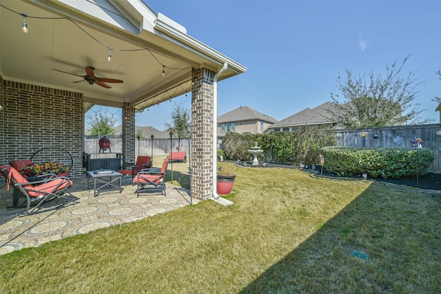 view of yard with ceiling fan, a patio, and a fenced backyard