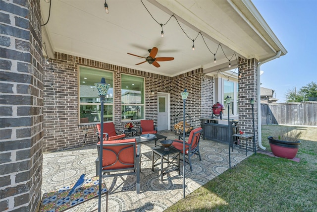 view of patio featuring ceiling fan and fence