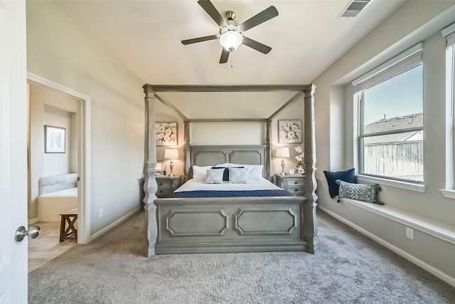 bedroom featuring a ceiling fan, visible vents, baseboards, carpet, and decorative columns