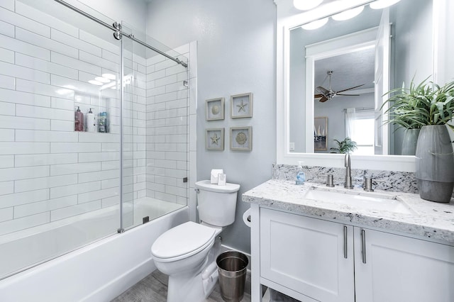 636 Villa Dr, Crystal Beach, TX 77650 - full bathroom featuring toilet, bath / shower combo with glass door, vanity, and a ceiling fan