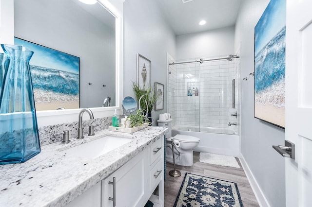 636 Villa Dr, Crystal Beach, TX 77650 - bathroom featuring shower / bath combination, baseboards, toilet, wood finished floors, and vanity
