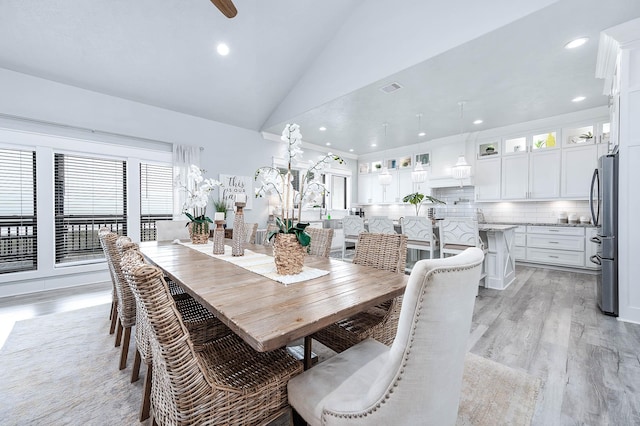636 Villa Dr, Crystal Beach, TX 77650 - dining area featuring lofted ceiling, visible vents, light wood finished floors, and recessed lighting