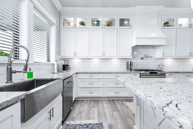 636 Villa Dr, Crystal Beach, TX 77650 - kitchen with custom range hood, appliances with stainless steel finishes, ornamental molding, white cabinetry, and a sink